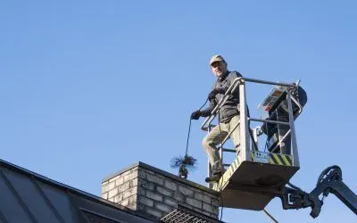 Raasiku,,Estonia,-,May,04,2024:,Worker,In,Crane.,Man Raasiku, Estonia - May 04 2024: Worker in crane. Man on rental lift hoist cleaning the chimney of his own home. Fire safety measurements. Spring cleaning season.